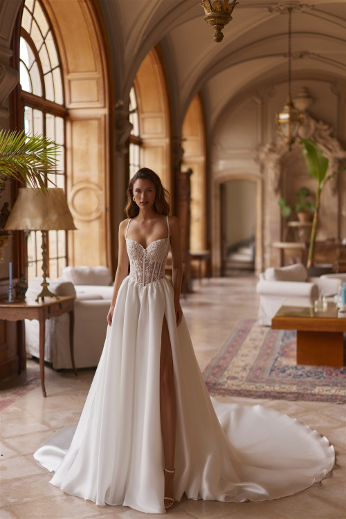 Wedding dress with corset, thin straps, slit, and train