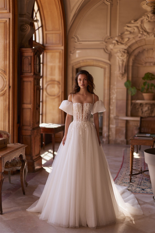 Wedding dress with corset, puffy drooping sleeves, thin straps, and train